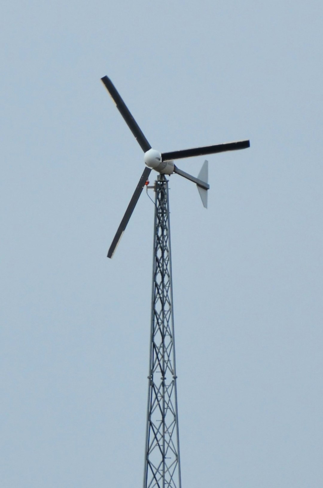 a-wind-turbine-stands-tall-against-a-clear-sky-3qwho1ljtis